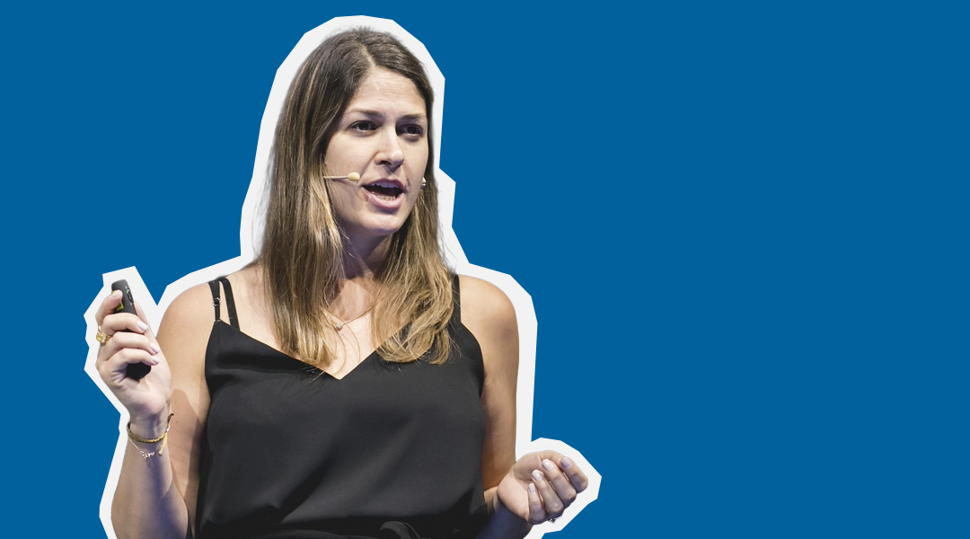 Image of female presenter speaking with slide control