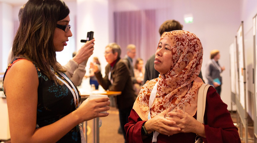 Image of two women discussing a poster presentation